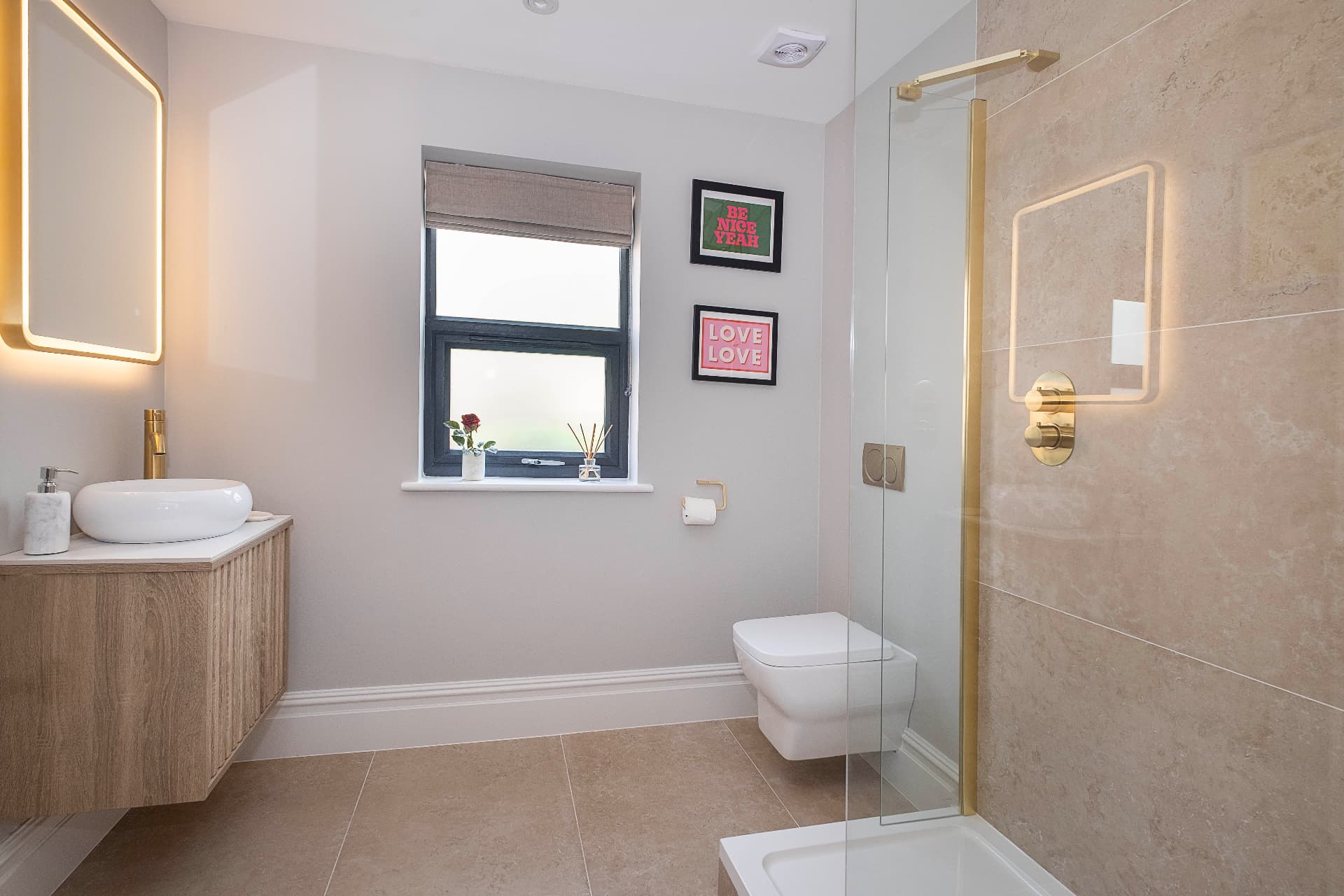 Bathroom with a timber vanity, vessel sink, illuminated mirror and glass shower screen